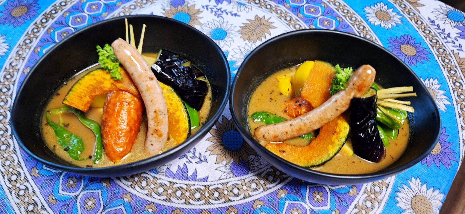 ソーセージとかぼちゃ、なすなど野菜がたっぷり入ったスープカレー2皿